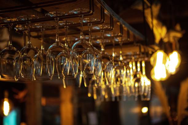 istock Closeup of empty wine glasses hanging from a hanging rack 1440966247