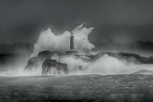 Giant waves with the force of the sea jumping Island and lighthouse.