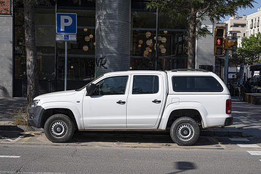 Barcelona, Spain – June 18, 2021: Barcelona, ​​Spain; June 15, 2021: White suv parked on the city street. It's a Volkswagen Amarok