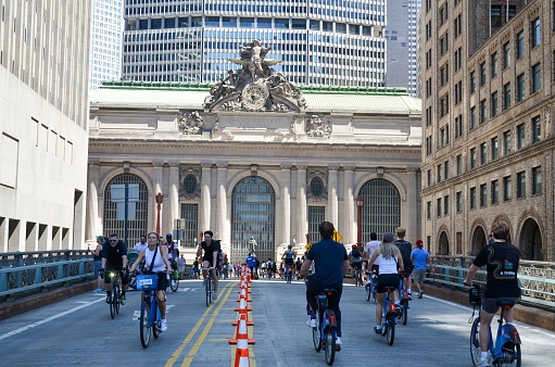 New York, United States – August 06, 2022: A New York street view with people walking and biking around during a car-free Summer Streets event along Park Avenue