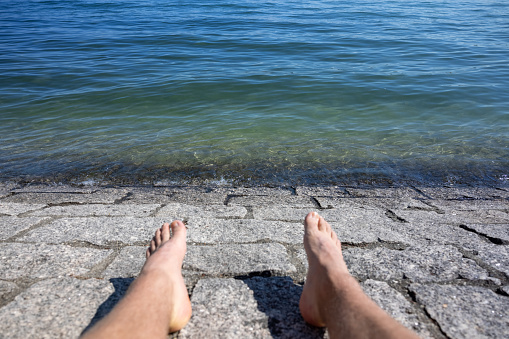 A person sitting by Lake Constance in Constance, Germany