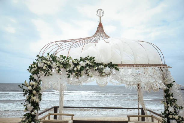istock Beautiful wedding gazebo on the beach under a cloudy sky 1440967711