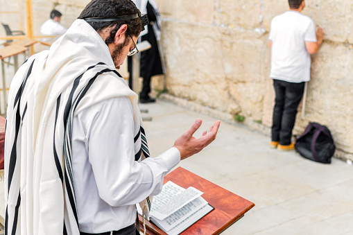 A young Orthodox Jewish man praying with phylacteries, at the Western Wall.