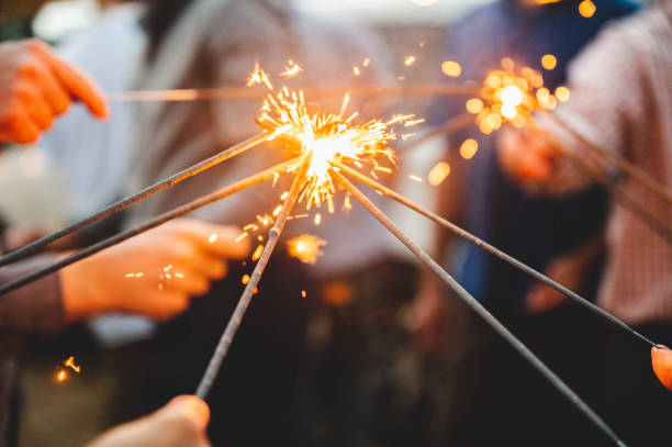 istock Selective focus shot of people with lighted sparkles during the evening 1440968613