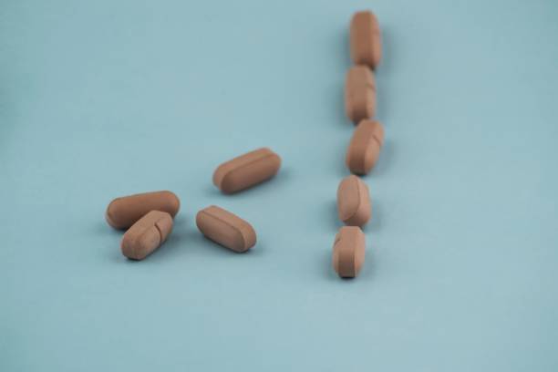 istock Pile of pills on a blue background 1440969150