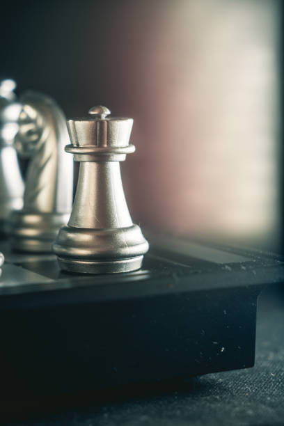 istock Vertical closeup shot of an arranged chessboard with metallic silver pieces 1440969973