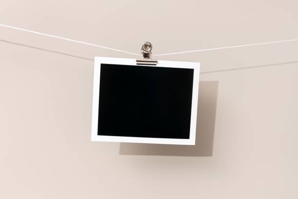 istock Blank Vintage instant photo frame hanging on a rope 1440970036