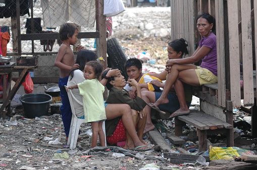 manila, Philippines – October 20, 2011: The Children in Smoky Mountain village sitting in front of a house, Manila, Philippines