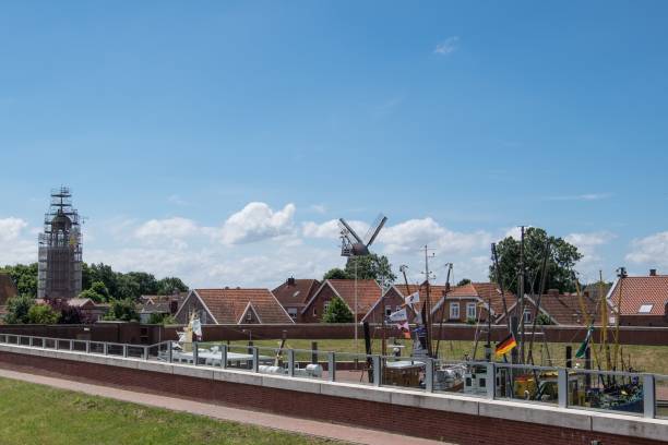 istock Low-angle view of a windmill and modern houses in Ditzum, Germany 1440971335