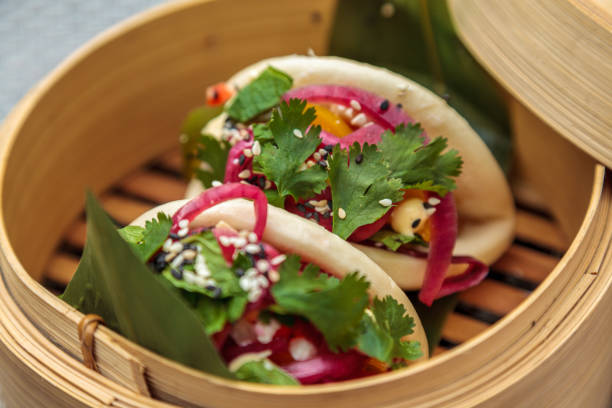 Closeup shot of baos served traditionally in a bamboo basket-good idea for shanghai cuisine ad