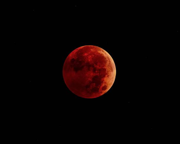 istock Clear view of the lunar eclipse in the dark sky - red moon 1440971810