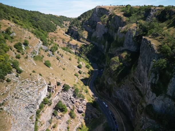 istock Aerial view of a road passing through a valley surrounded by tall cliffs and mountains 1440972069