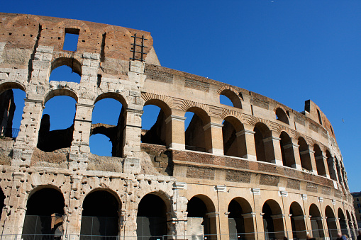 Coloseum against bright blue sky in Rome Italy