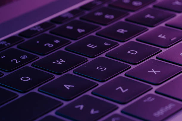 istock Closeup of an Electronic keyboard with glowing buttons with purple theme light 1440973225