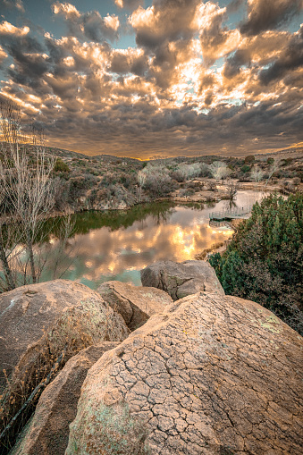 A vertical shot of the sunset at Fain Lake in Fain Park, Prescott Valley, Arizona