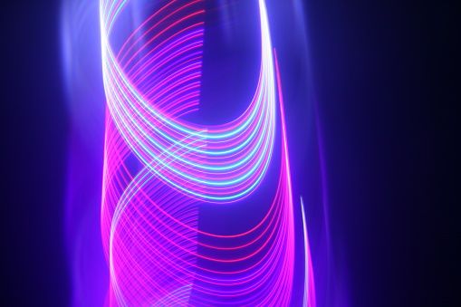 An abstract moving pink and blue neon lights for techno wallpaper or background