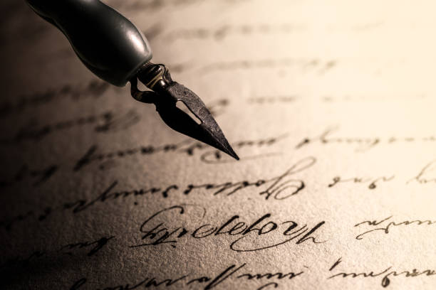 istock Old pen over the old manuscript, old writing, archival materials, old letter, handwriting, 1440975447