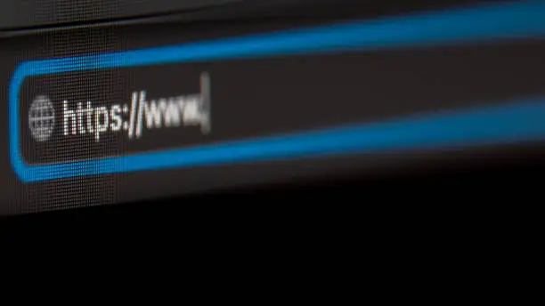 Photo of Browser close-up with https. Black background. LCD screen