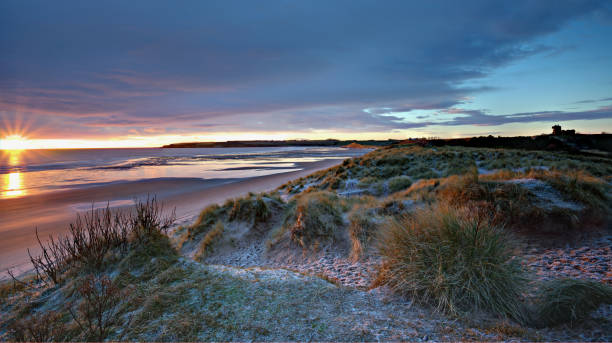 istock Rising sun at Lunan Bay, Angus, Scotland. 1440976256