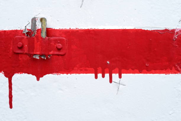 Rusty Hanger on White Grunge Concrete Wall with Red Painting Line.