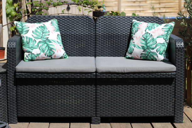 istock Two-seater sofa with its cushions on a terrace under a bright sunlight 1440977720