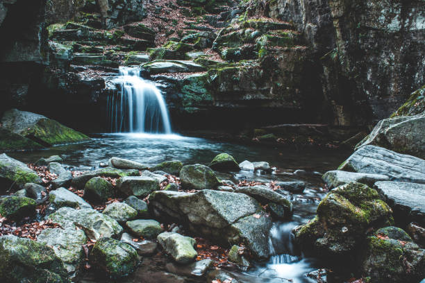 istock Low angle shot of a waterfall flowing on a sunny day 1440977734