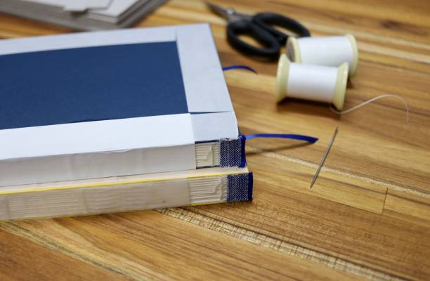 istock Selective shot of tools used in bookbinding process on a wooden table 1440977749