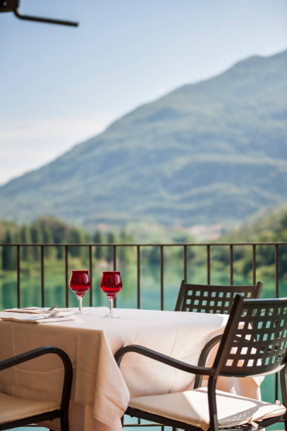 istock Selective of a table with wine glasses in a balcony facing the mountains 1440978471