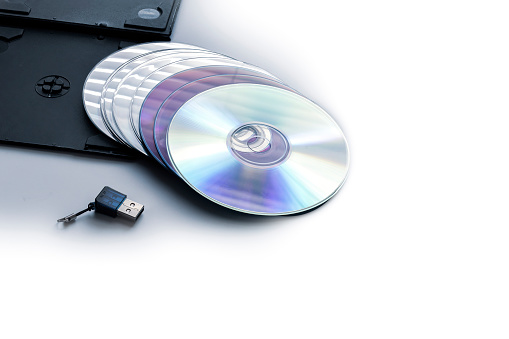A stack of CD and USB on white background with copy space.