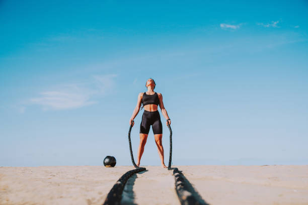 Functional training workout on the beach, fit and athletic woman doing sport outdoors - Concepts about lifestyle, sport and healthy lifestyle