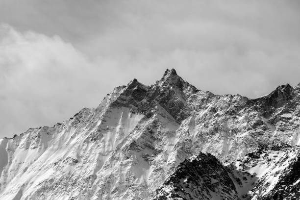 istock Grayscale of mountains under the cloudy sky 1440979664