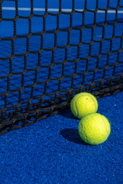 istock Two paddle balls on the surface of a blue paddle court. 1440979902