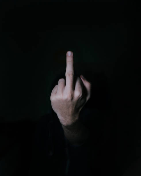istock Selective of a middle finger in the darkness 1440980777