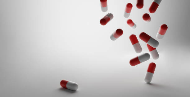 istock 3D illustration of some falling capsules on a white background. 1440982245