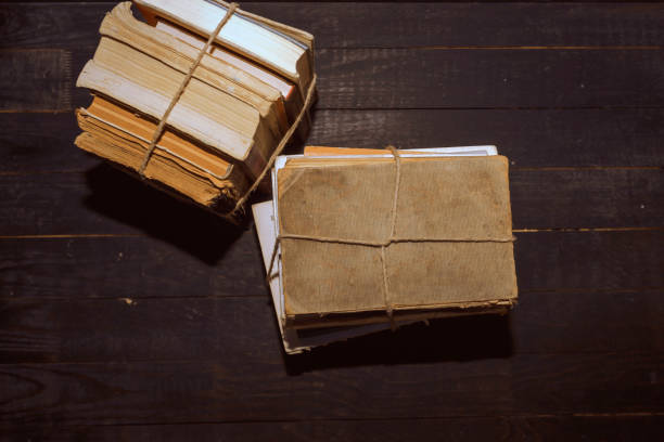 istock Old books with rope on a wooden table 1440982532