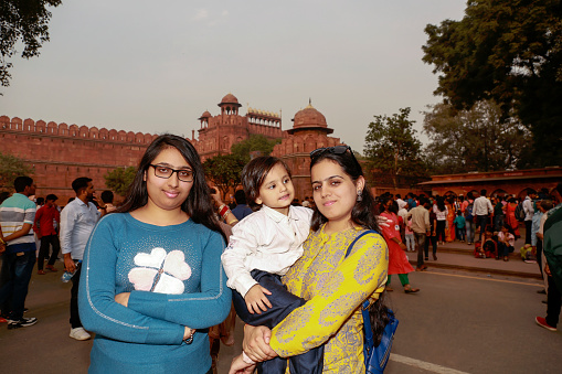 Indian family standing portrait near red fort New Delhi, India.