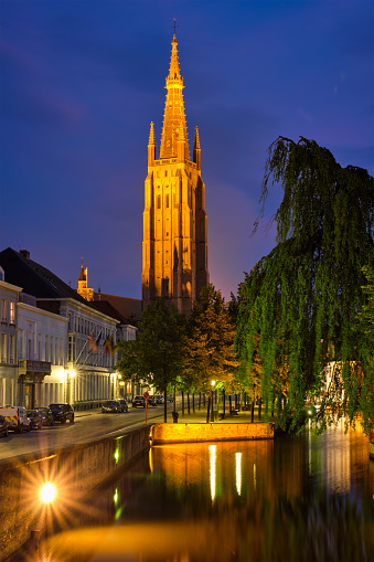 Church of Our Lady and canal illuminated in the night. Brugge Bruges, Belgium