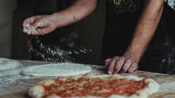 istock Selective focus shot of the process of making delicious pizza 1440984893