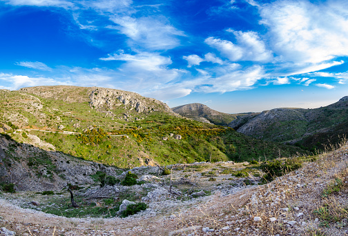 A mesmerizing view of Parnitha mountain range under a blue cloudy sky in Greece