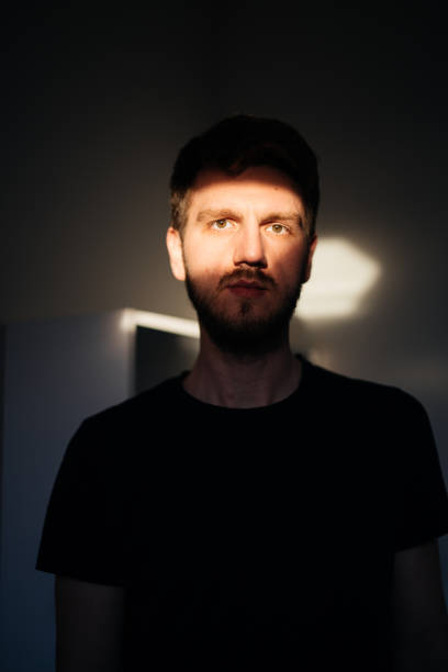 istock Handsome guy looking at the camera with sun rays falling on his face 1440985467