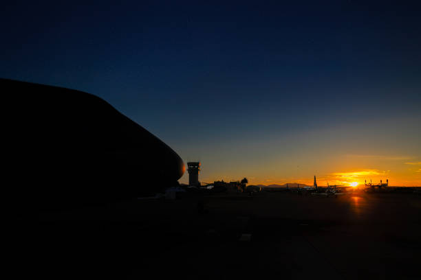 wing and turbine of a huge civilian airliner against the backdrop of sunset and glare of the sun