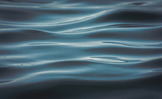 A closeup shot of deep blue sea waves