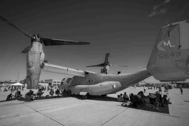 San Diego, California, USA - September 24, 2022: Airshow spectators get relief from the sun in the shade of a V-22 Osprey at the 2022 Miramar Airshow.