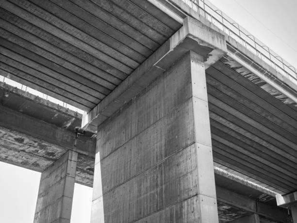 istock Grayscale low angle shot of a concrete bridge 1440986054