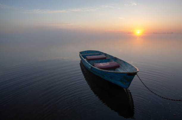 istock Lonely old boat on the very shore at sunrise 1440986069