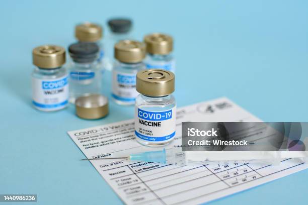 Closeup Image Of Vaccine Vial And Syringe On Cdc Covid19 Vaccination Record Card Stock Photo - Download Image Now