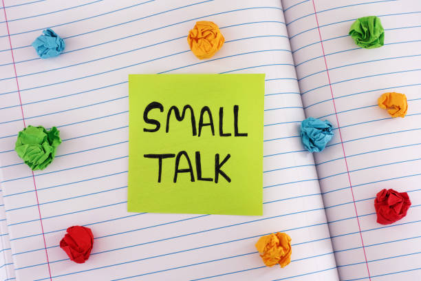 istock A green paper note with the words Small Talk on it on a notebook sheet with some colorful crumpled paper balls around it 1440986315