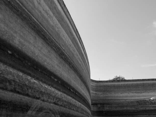 istock Grayscale shot of a rock formation under a clear sunny sky 1440986374
