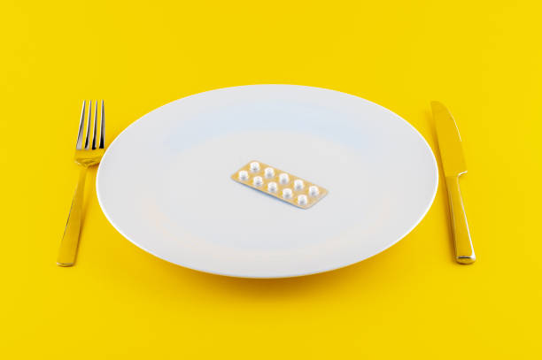 istock White plate with medicine on yellow background 1440988159