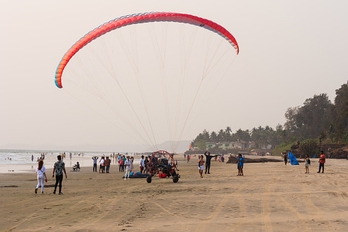 Goa, India – April 02, 2021: Motorised paragliding and paramotoring activities being conducted along Ashvem beach